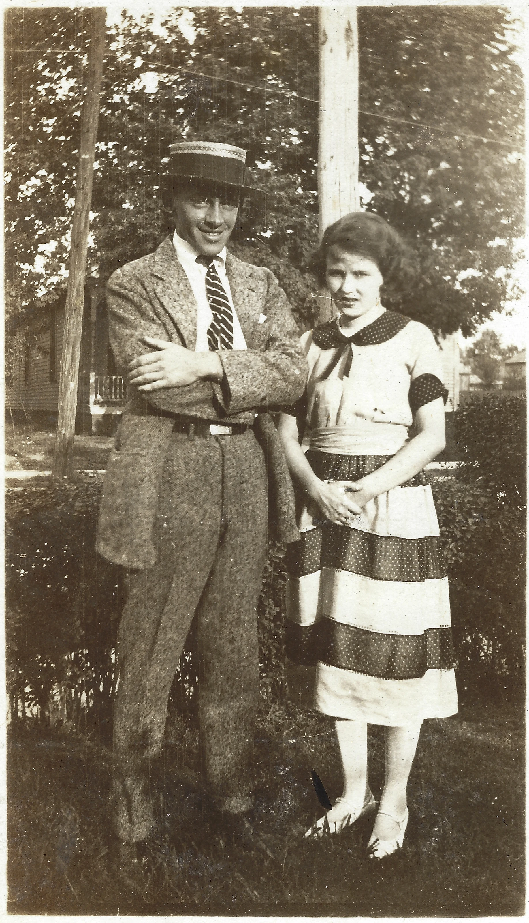 Mama Percy (Catherine Fleming) with her husband, Percy Kerby ("Father Percy"), a young man in a straw boater, standing outdoors, around 1925