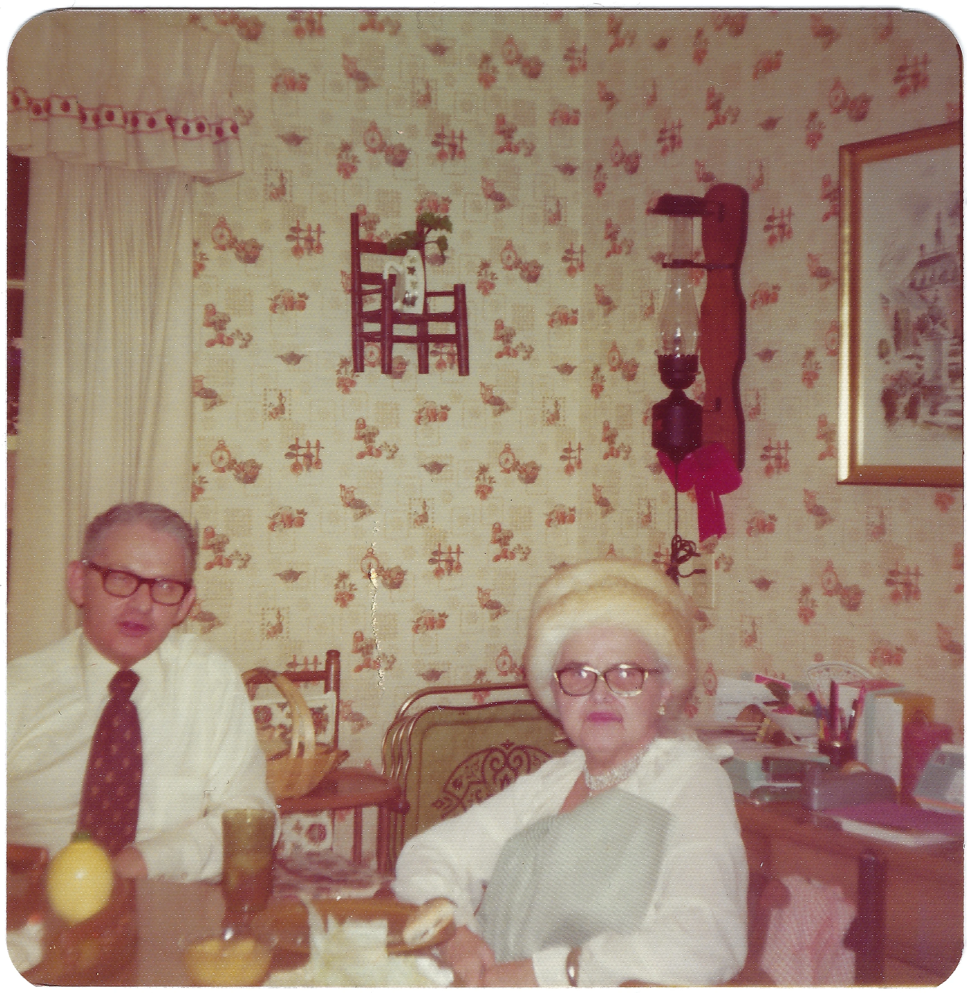 Mama Percy (Catherine Fleming) seated at a table with an elderly man — likely her second husband, Mr. Perkins — marked "Anniversary," around 1978