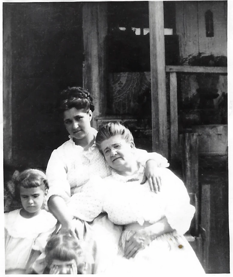 Three generations on a porch around 1915 — Catherine Purdie seated with her daughter Alconia Sutherland Fleming and young Mama Percy