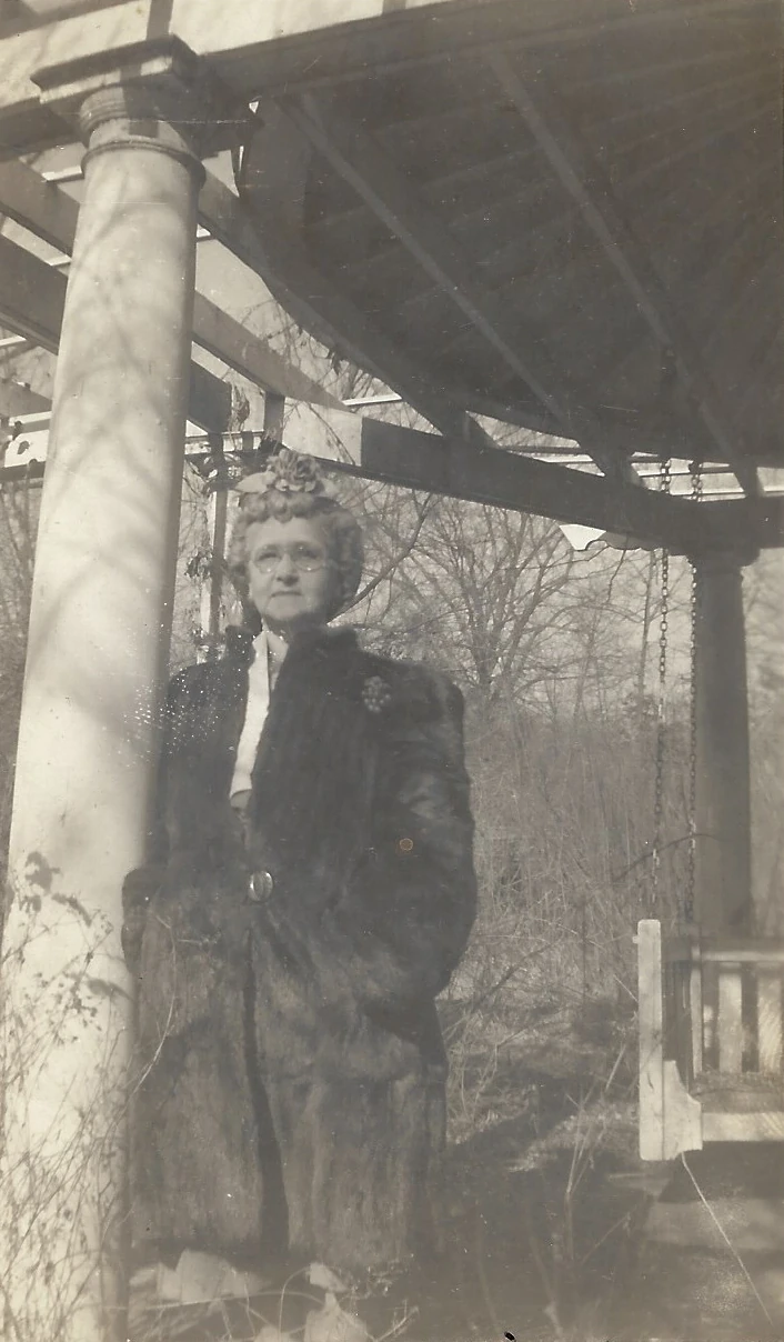 Alconia Sutherland Fleming standing by a porch column on January 8, 1945