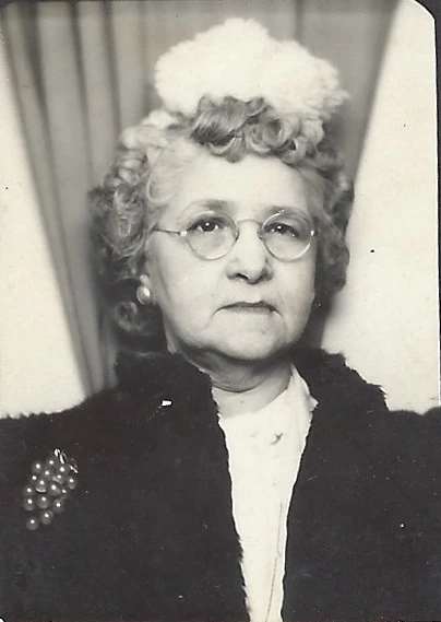 Alconia Sutherland Fleming wearing glasses and a dark fur collar, around 1952
