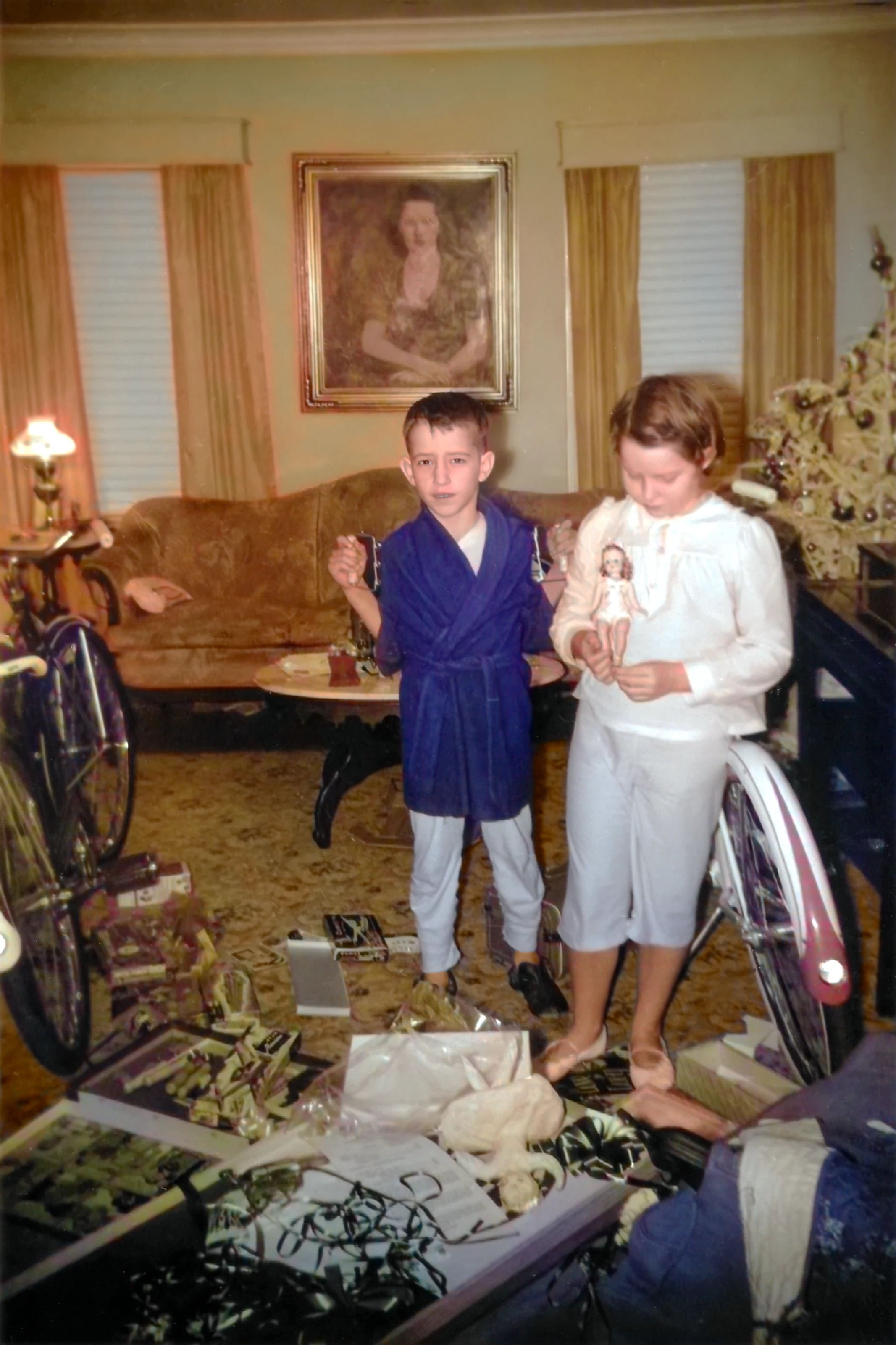 Cacky and David unwrap presents on Christmas morning in 1960
