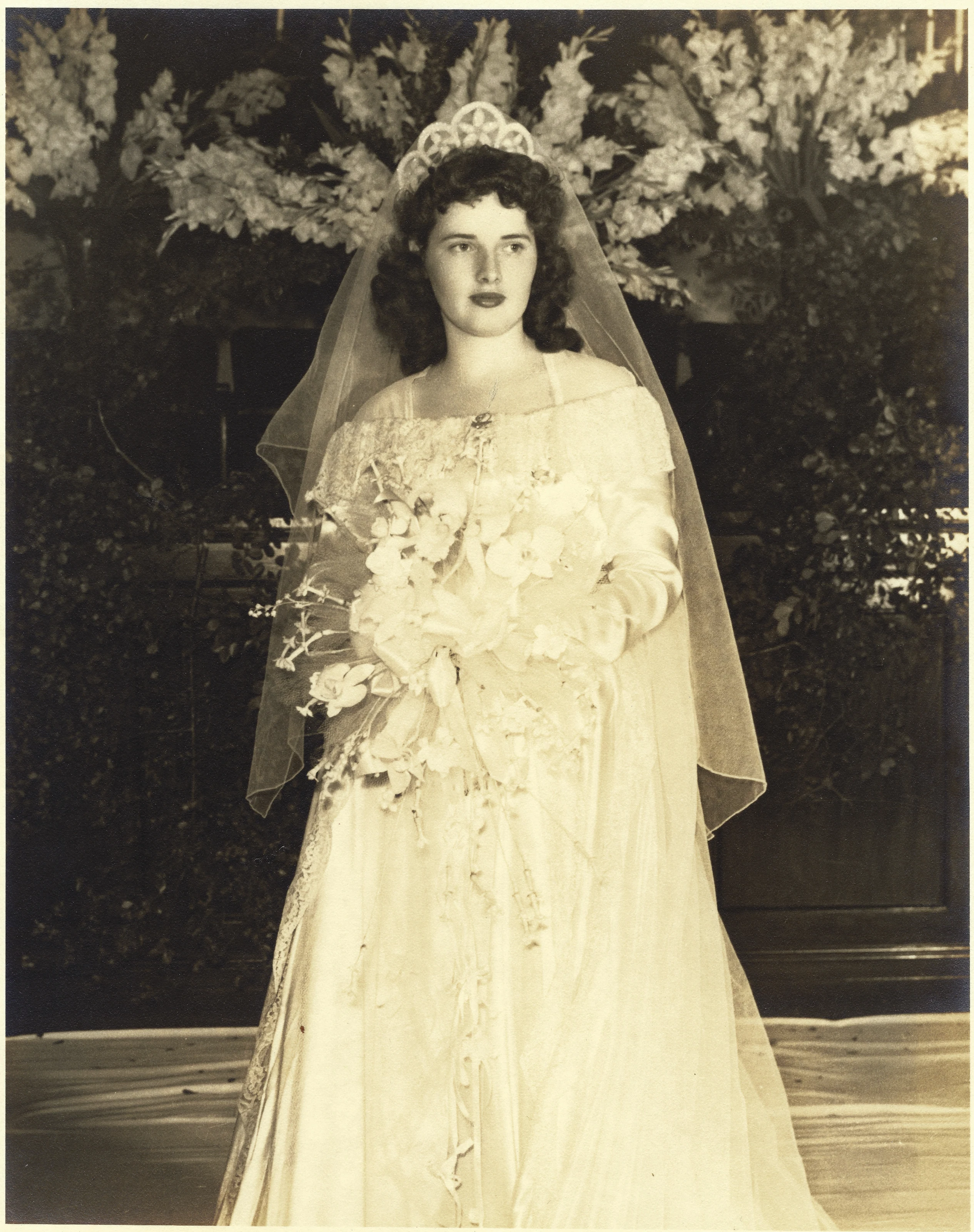 A 1940s bride in her wedding gown outdoors, from Gruzel's collection