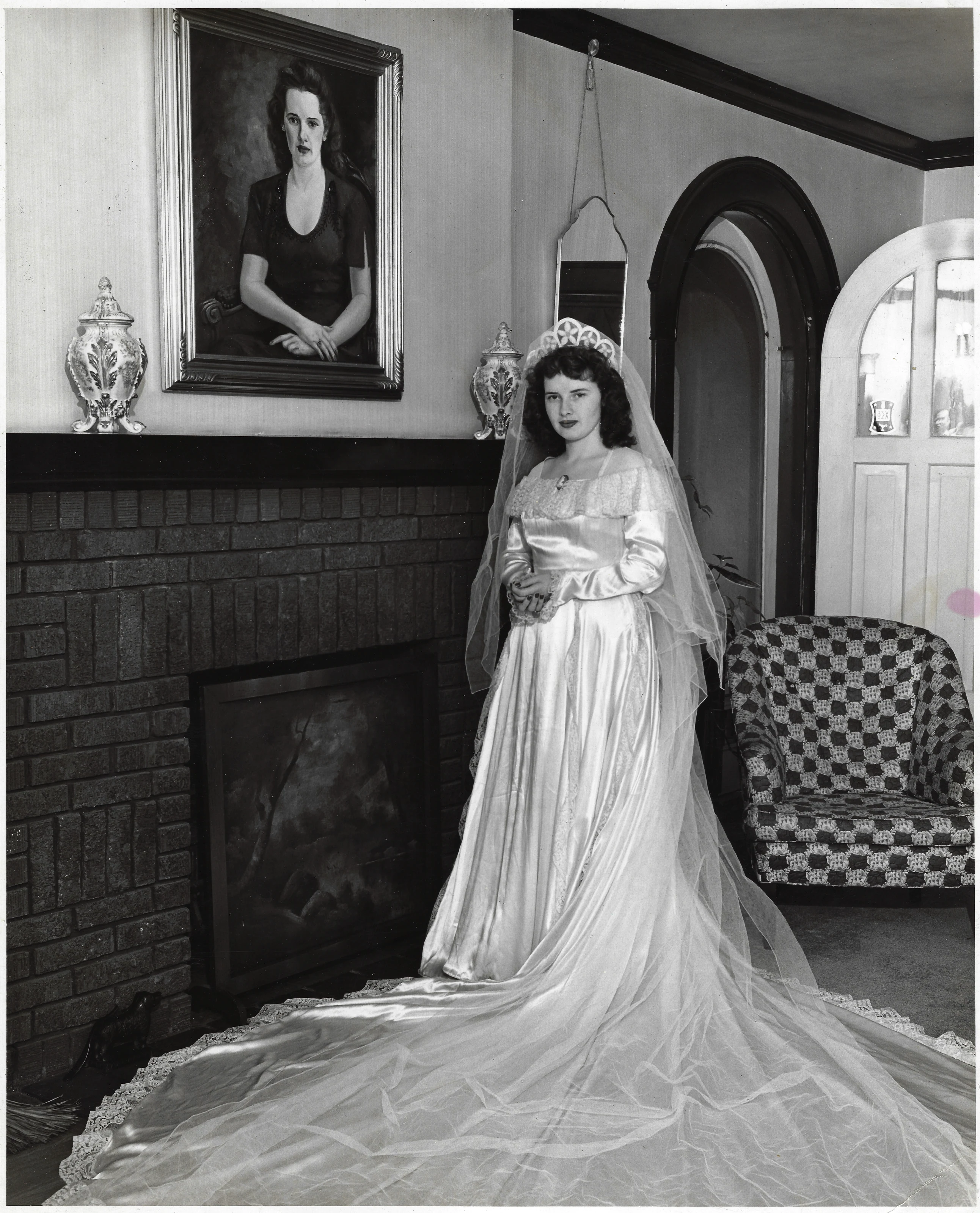 A 1940s bride in her wedding gown by a fireplace, from Gruzel's collection
