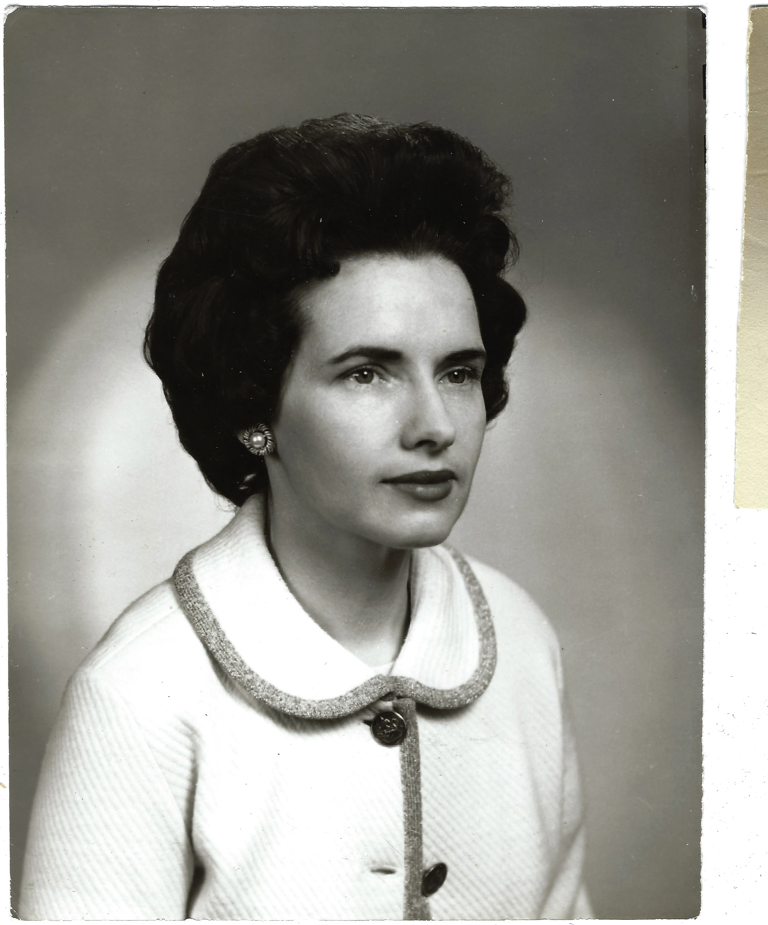 A studio portrait of Gruzel (b.1924) in a white knit jacket with braid trim and pearl earrings, around 1966