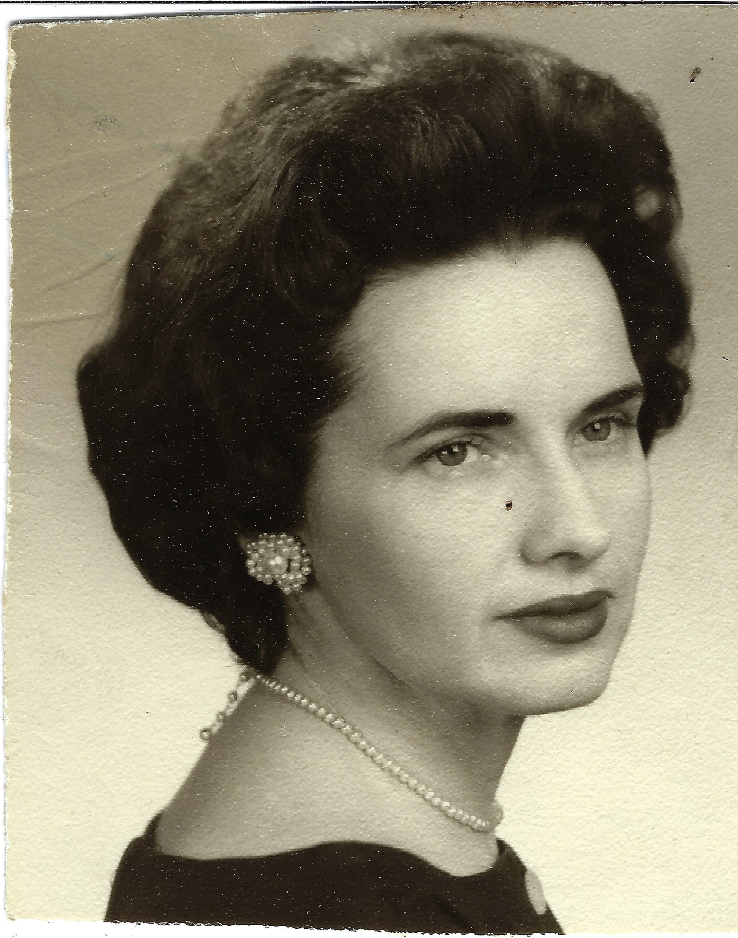 A sepia studio portrait of Gruzel (b.1924) with pearl jewelry and a bouffant, around 1960