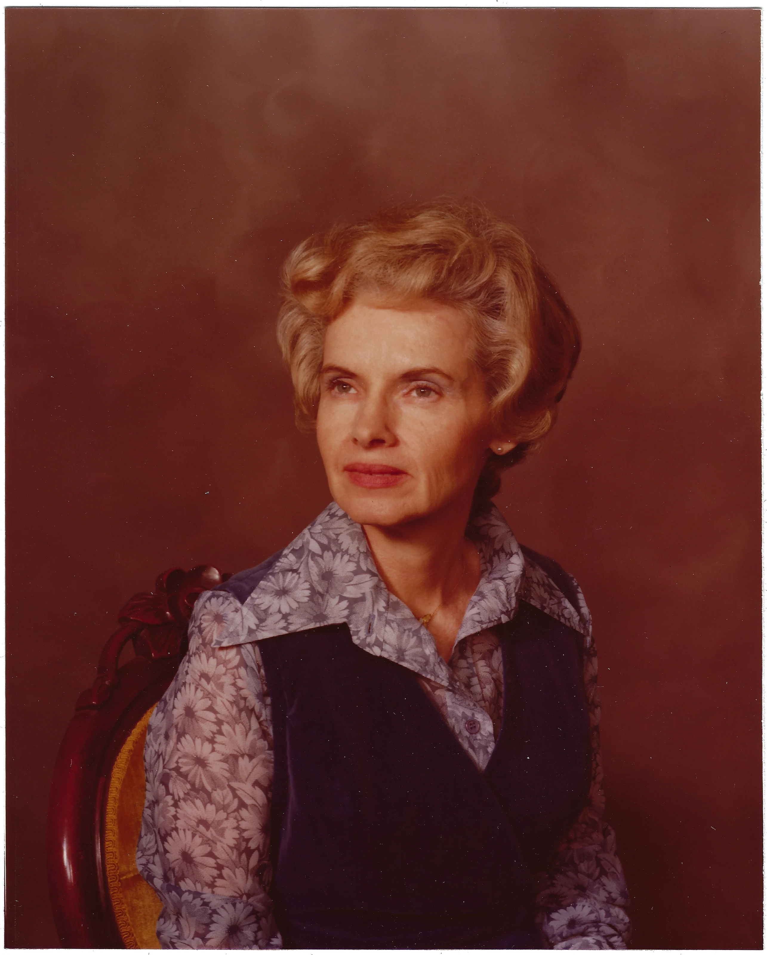 A color studio portrait of Gruzel (b.1924) in a floral blouse and navy vest, around 1974
