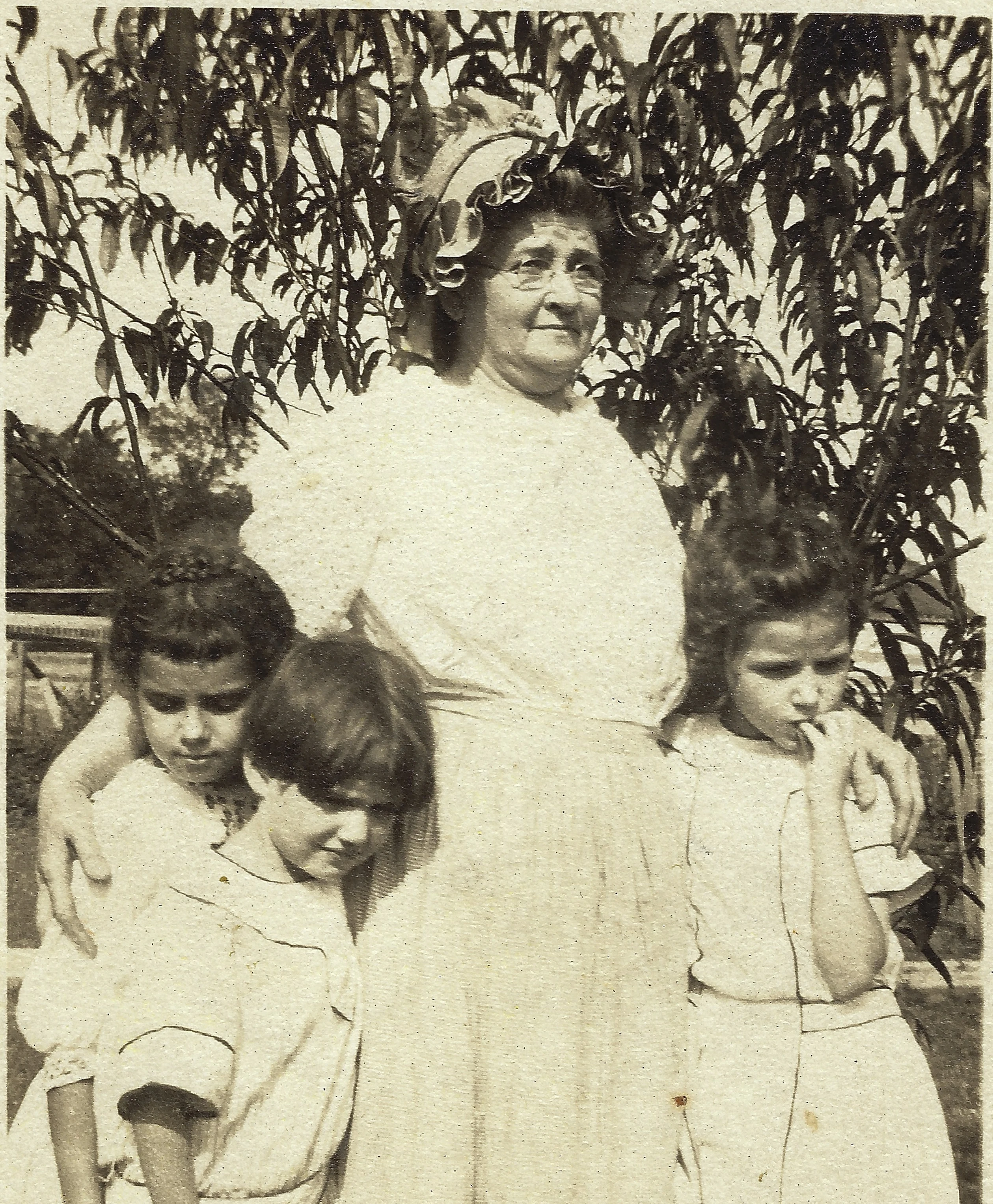 Garden photograph of Catherine Purdie (Sutherland Cox, b.1857) with children, around 1915