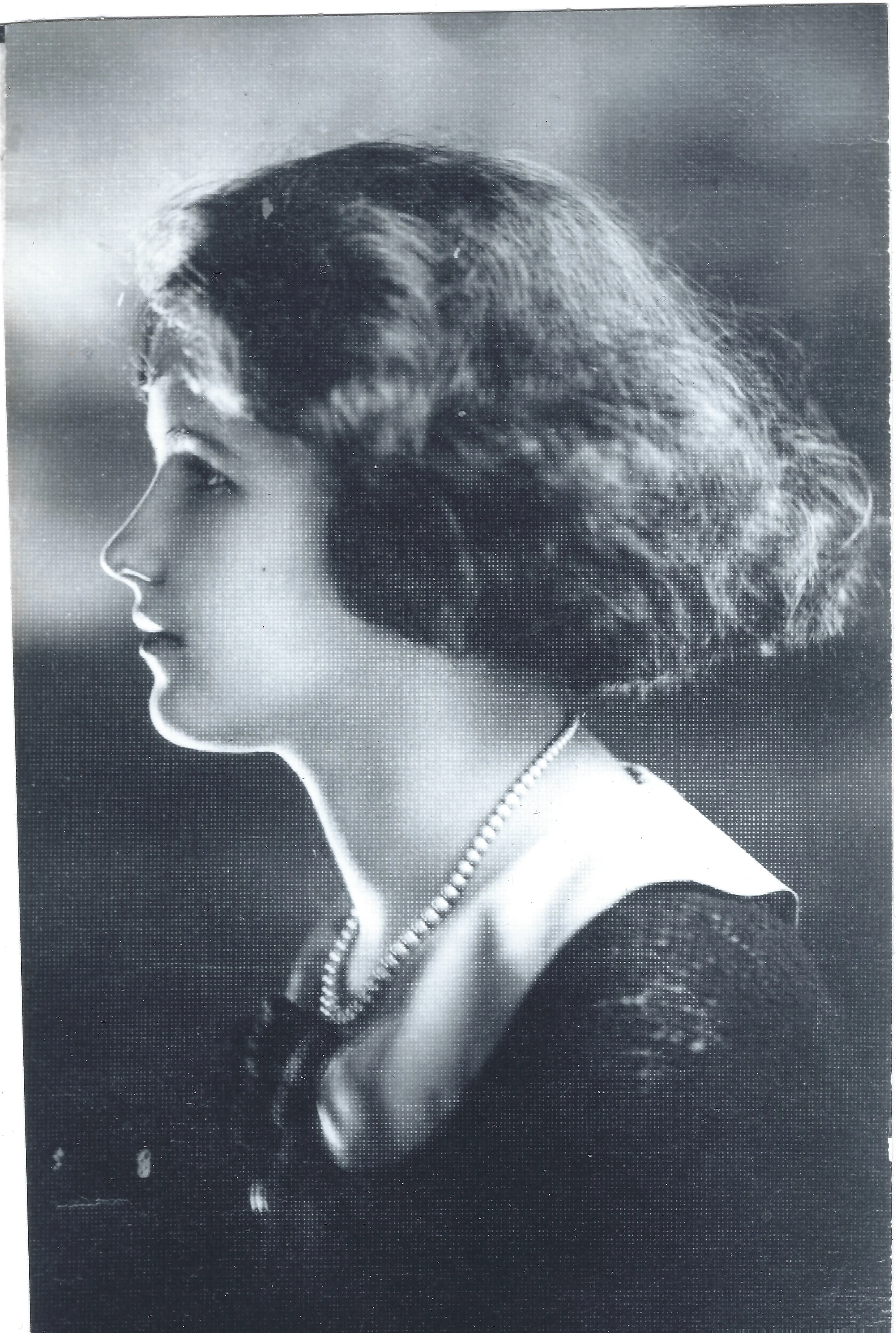 Soft-focus profile portrait of Mama Percy (Catherine Fleming) as a young woman with bobbed hair and a pearl necklace, around 1925